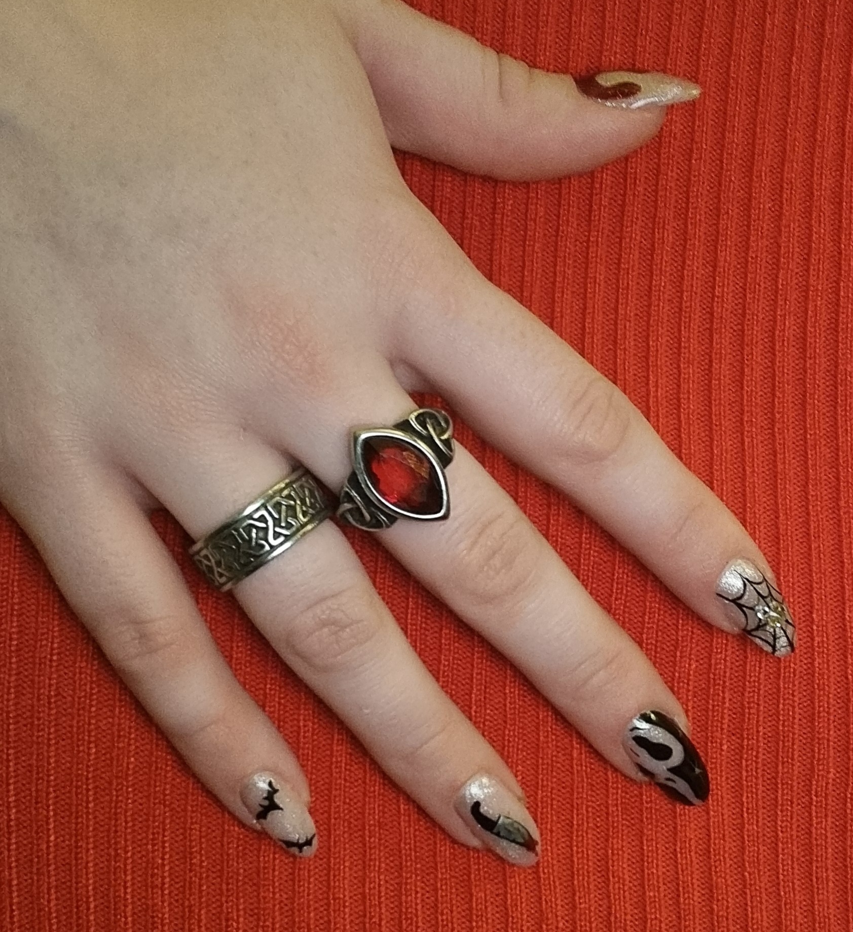 Nude Halloween-nagels met zwarte vleermuisjes en een spinnenweb
